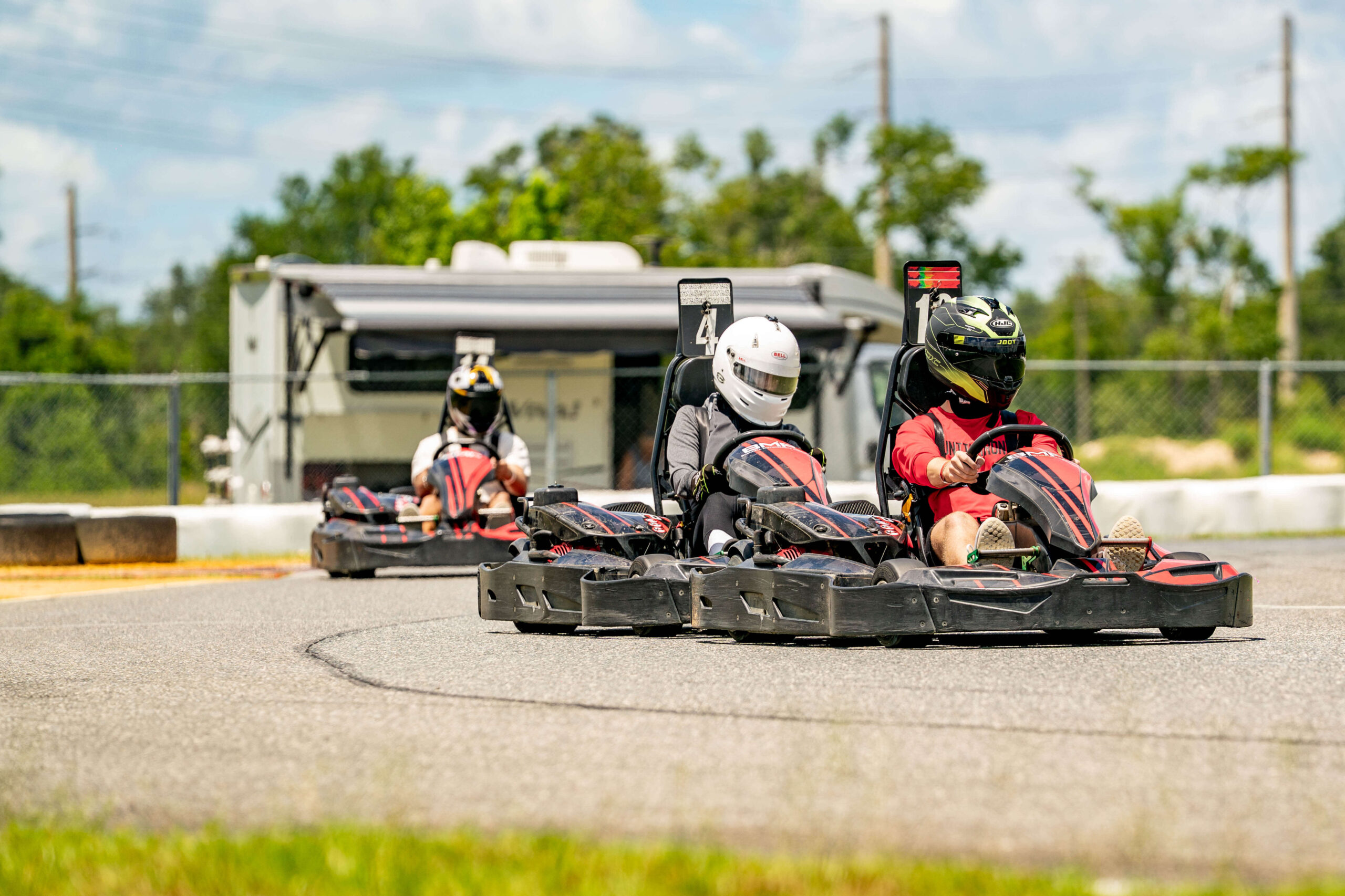 Three karts running together through a corner at Bushnell Motorsports Park